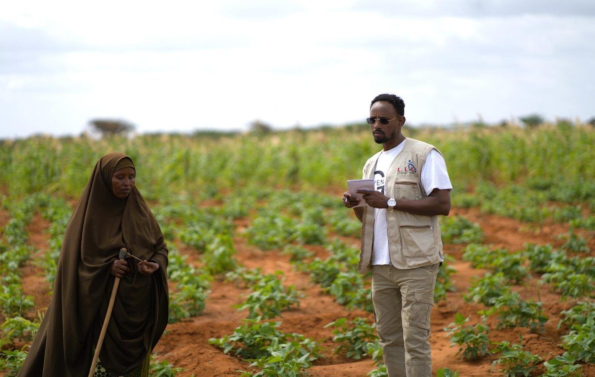 Fatuma walking through her cooperative plot outside Shimbirole East